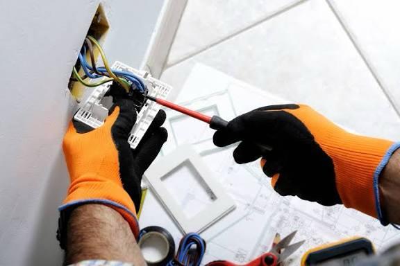 Electrician installing an electrical switchboard